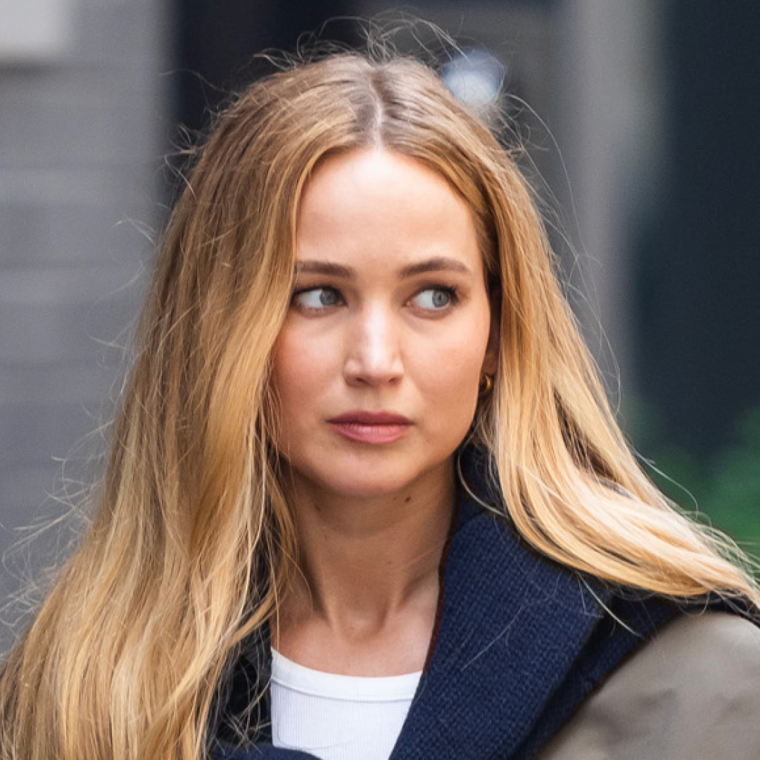 Jennifer Lawrence has long blonde hair and wears Ugg slippers and carries a Liffner basket bag