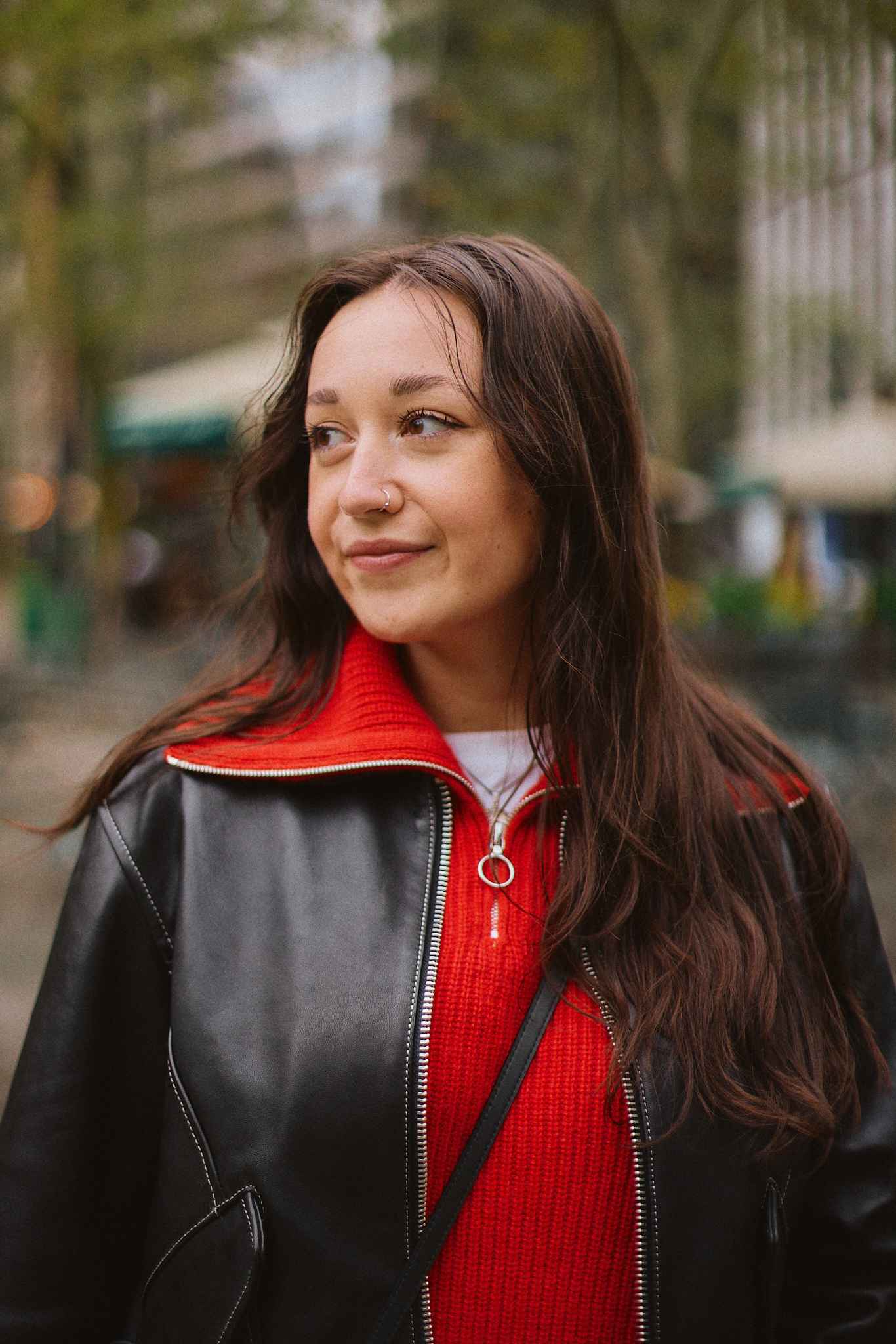 portrait of emma childs in a red sweater and leather jacket