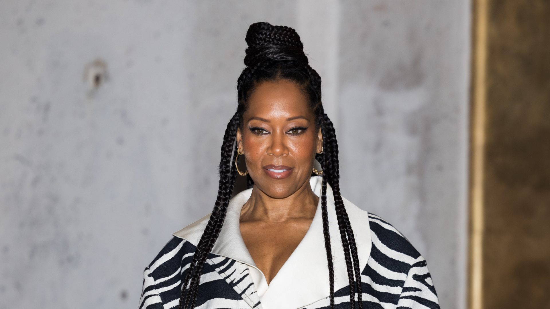Regina King wearing a high bun hairstyle