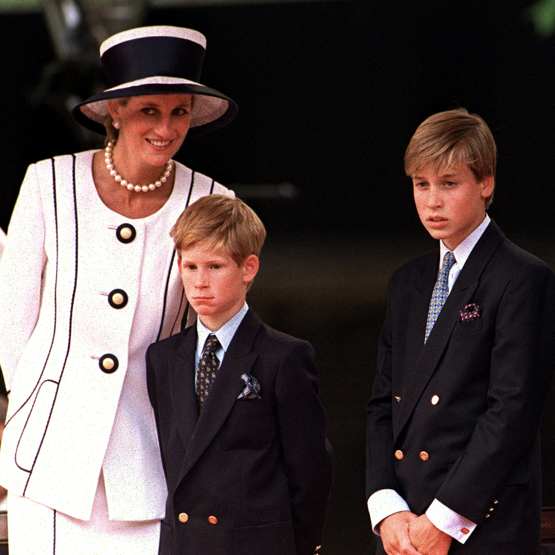 Princess Diana wears a white suit and matching hat with black piping, and poses with her sons Prince Harry and Prince William