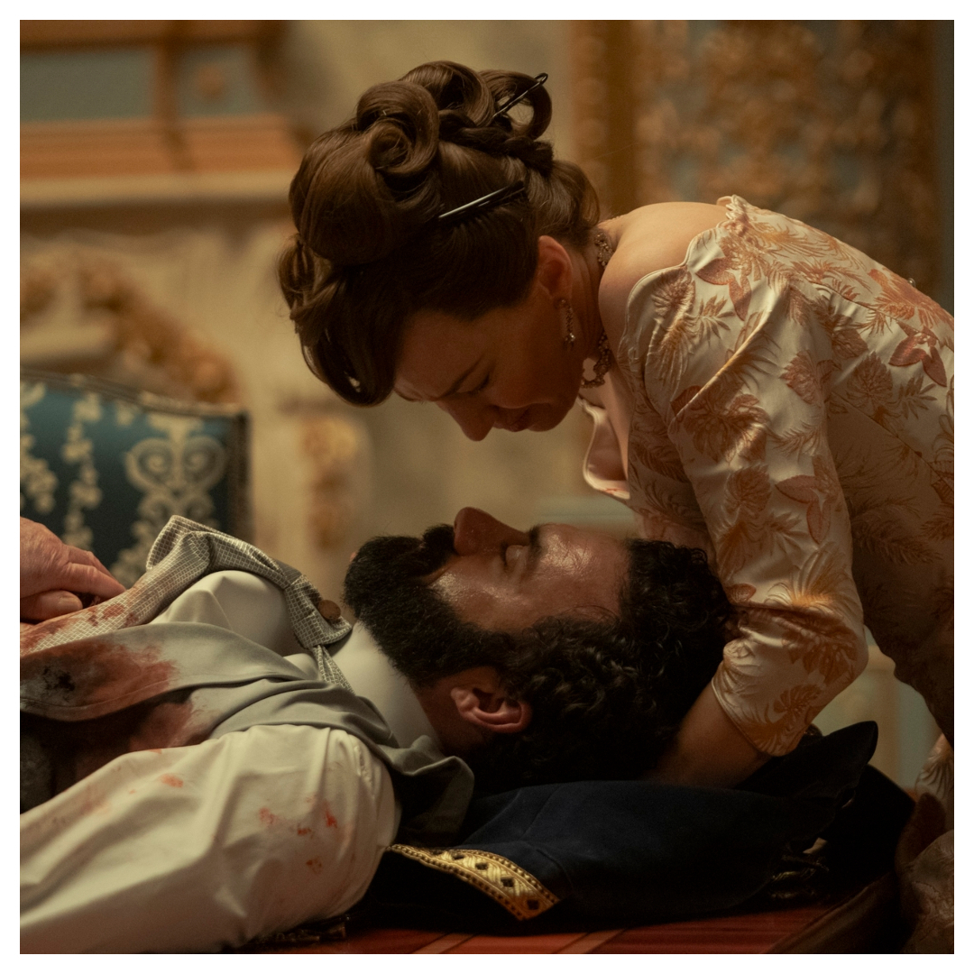 george russell lays under bertha russell bloodied and sick in a still from the gilded age season 3 finale