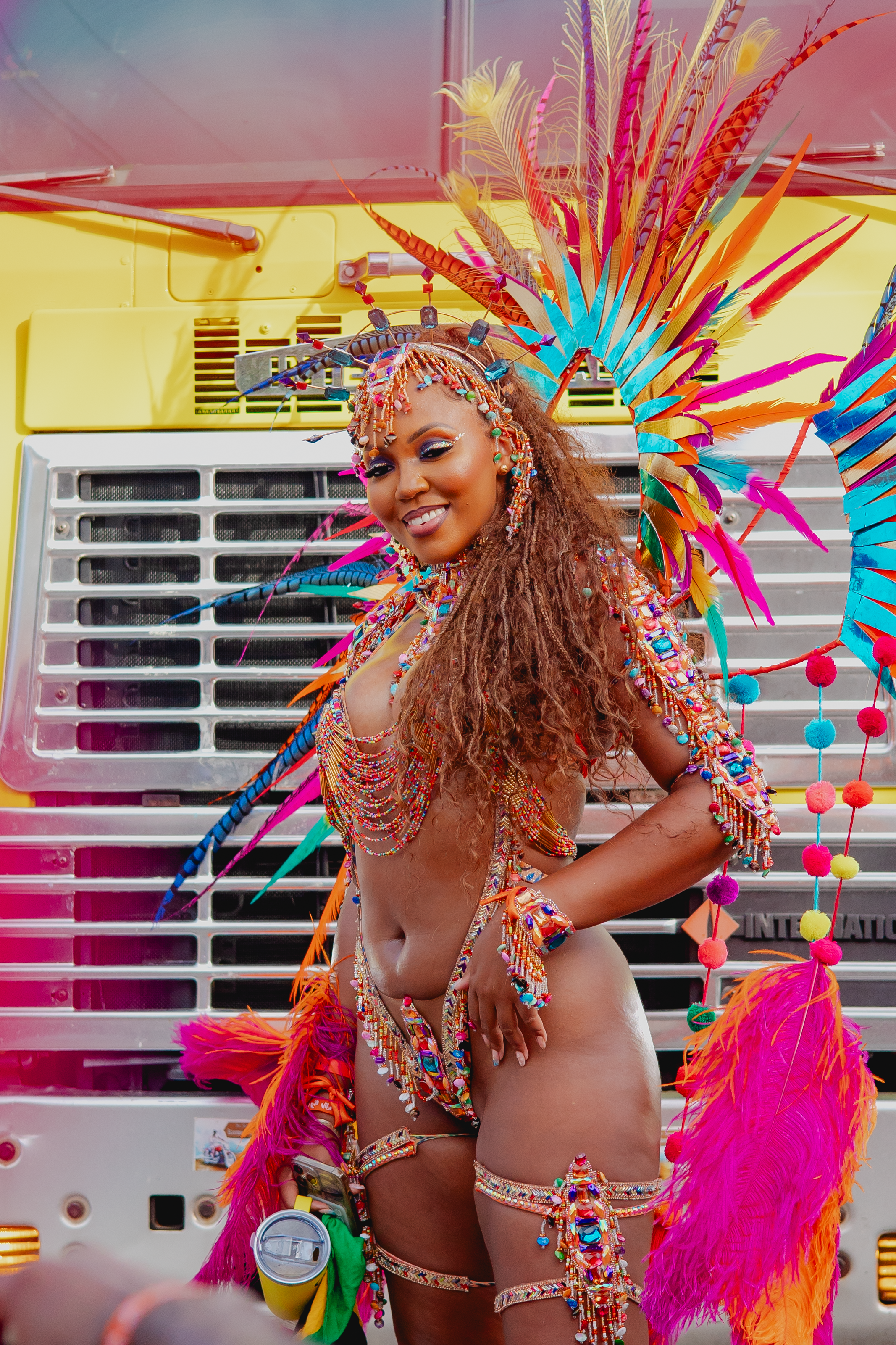 woman at carnival in a pink feather costume